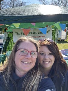Amy and Lauren selfie in front of the exhibition stand